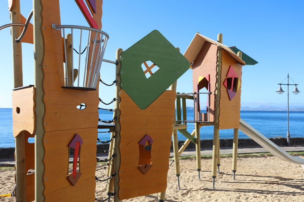 single mum holidays - playground overlooking the beach