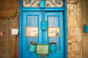 Crete facts - blue door with flower pots in Crete