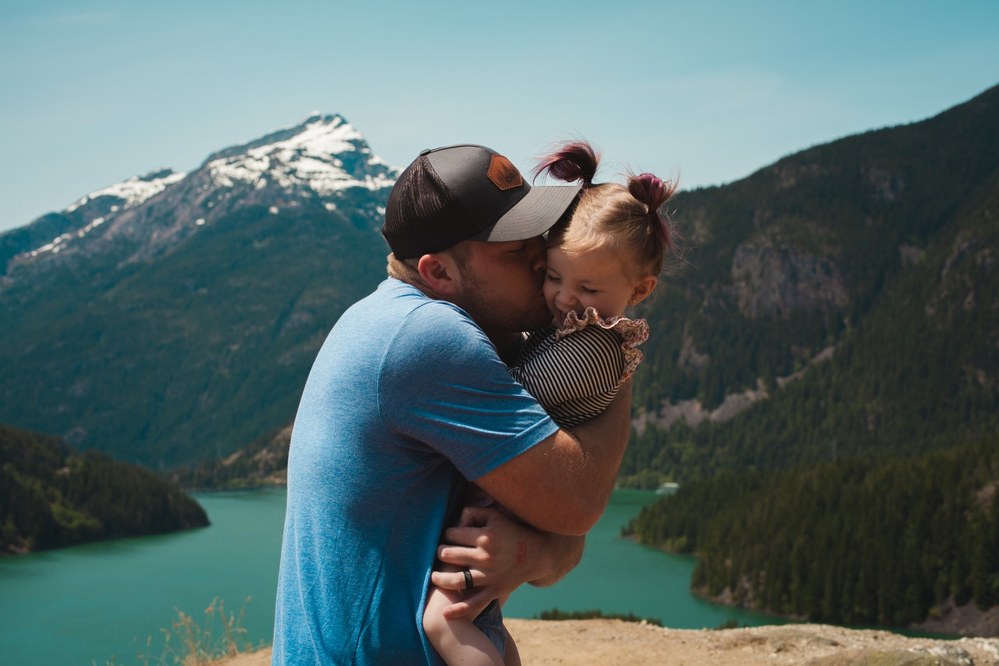single dad holidays - dad with daughter in mountains