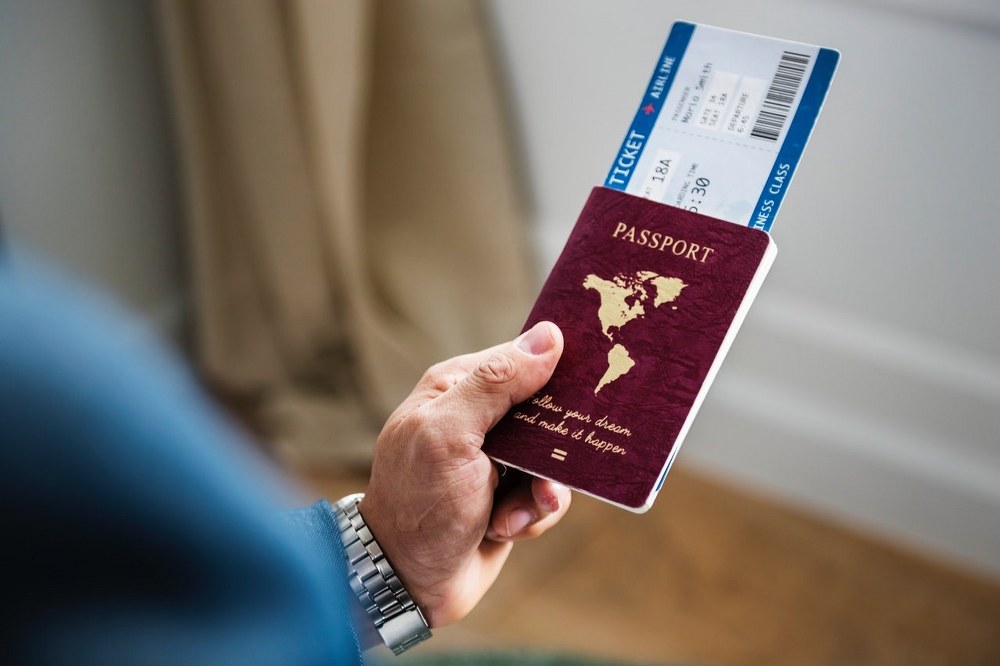 why do flight prices change - man holding passport