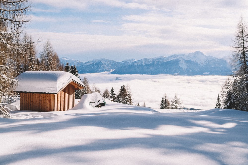 snow covered hut in winter landscape in Austria