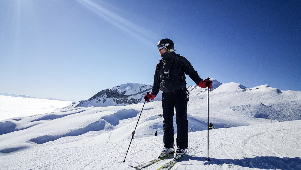 skier looking down on piste in sunshine Wilder Kaiser-Brixental - best ski resort 2020