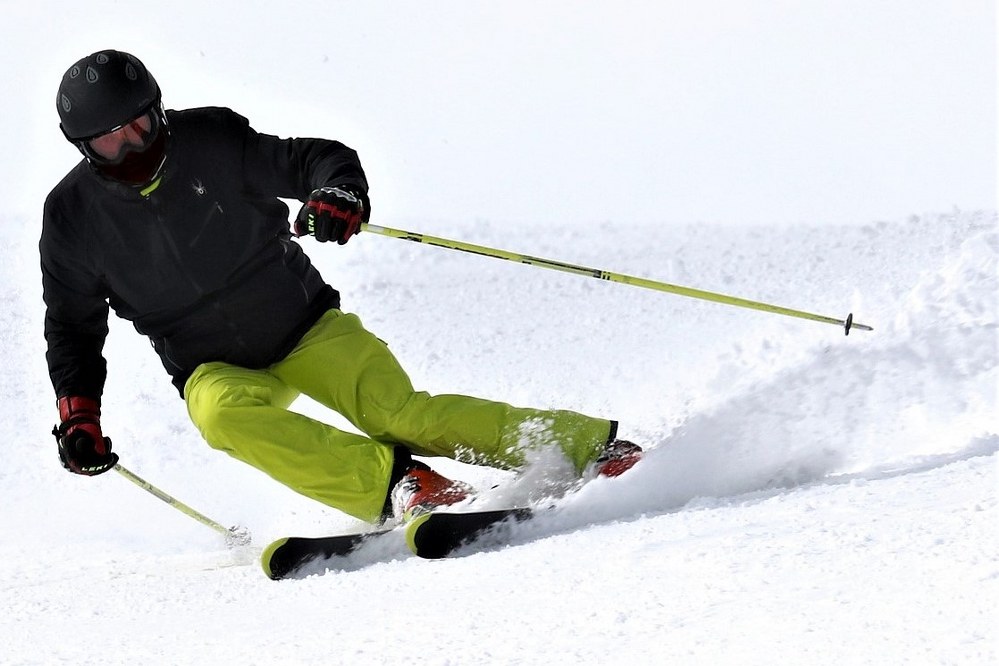 A man skiing down a snow covered slope