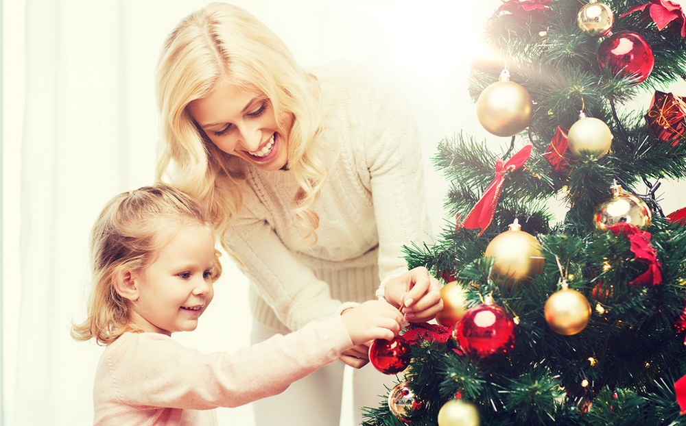 single mum and daughter decorating xmas tree