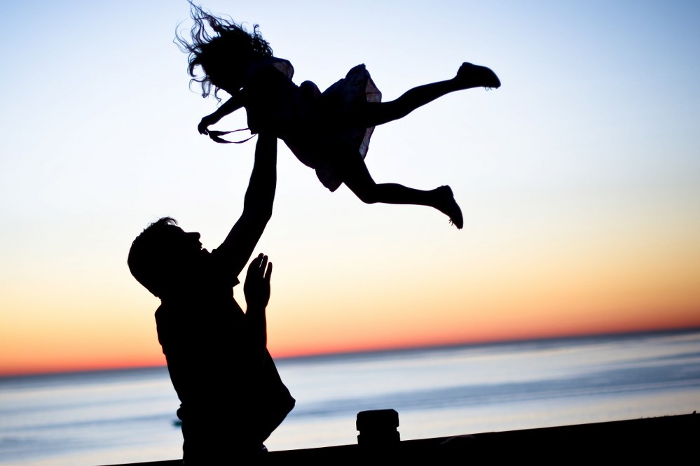 single dad and daughter with sunset