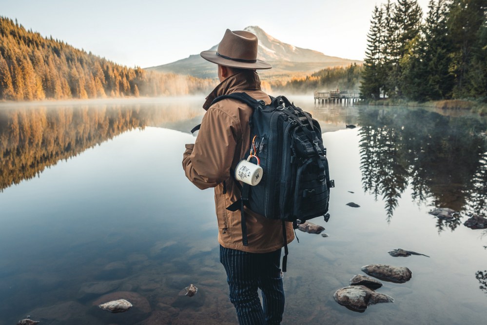 lone male traveller looking over lake