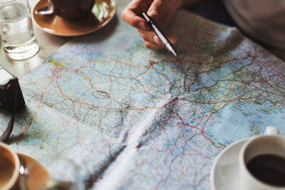 solo planning travel with map and coffee