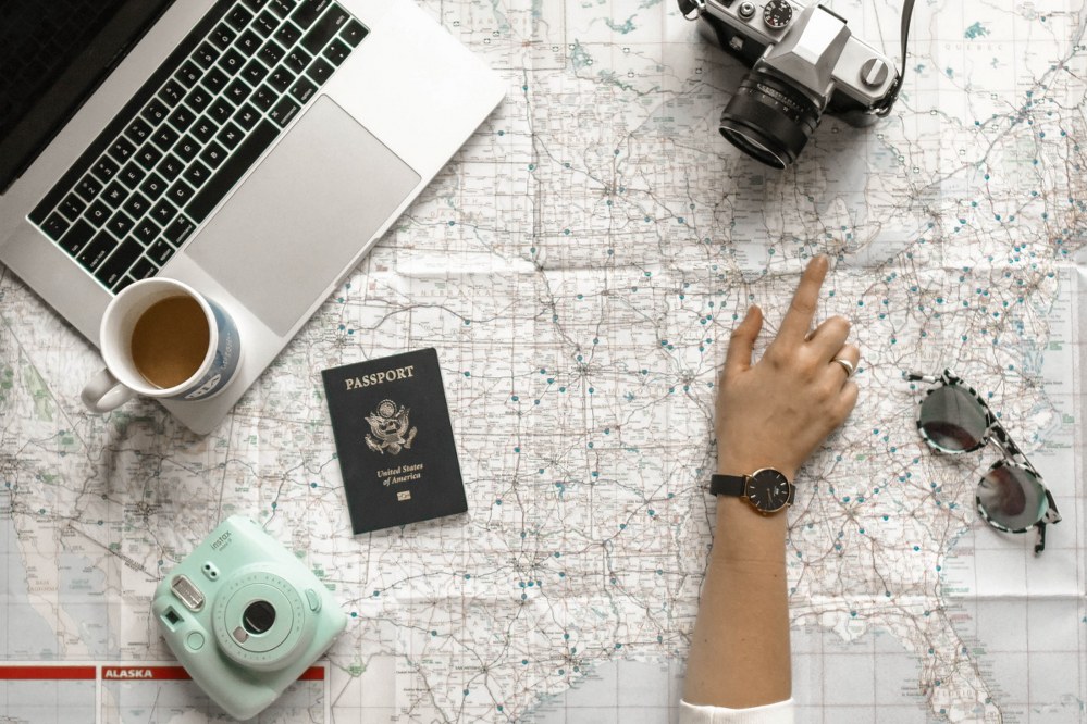 best apps for solo travellers - woman pointing at map