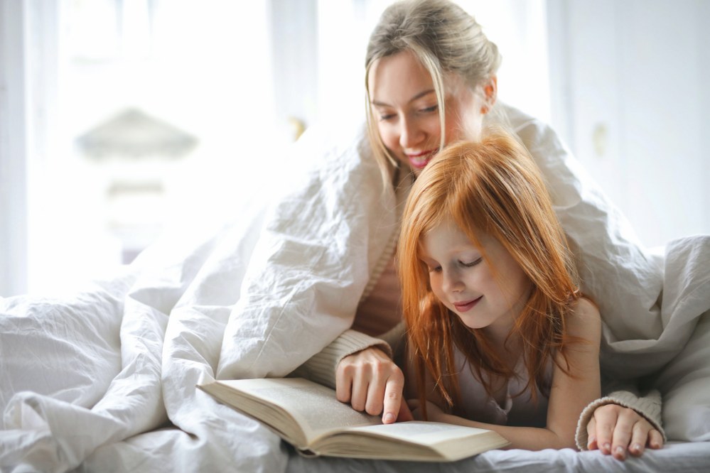 single mum and daughter in bed