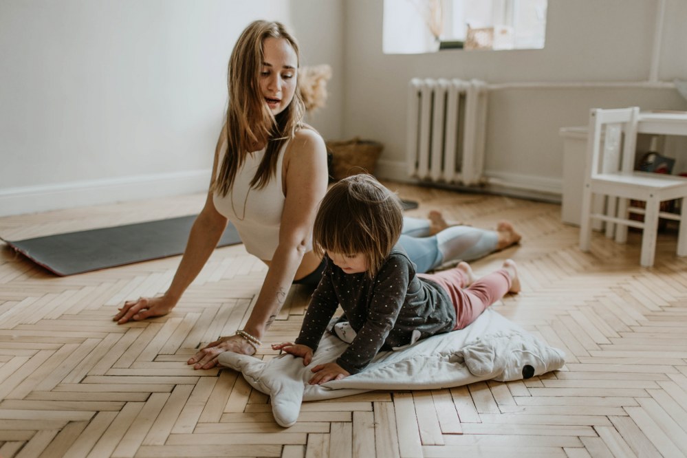 single mum and child doing yoga at home