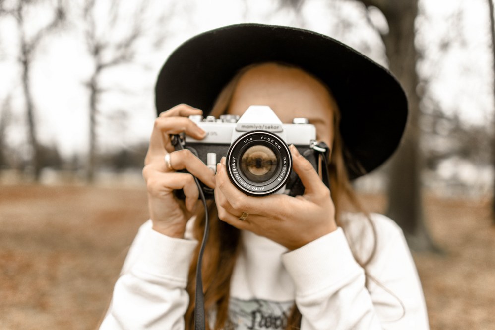 woman with camera taking photo for 5-star online dating profile