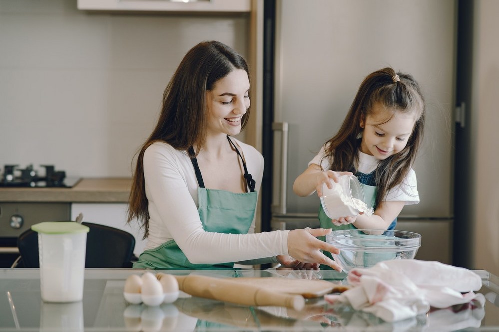 happy single mum and daughter baking