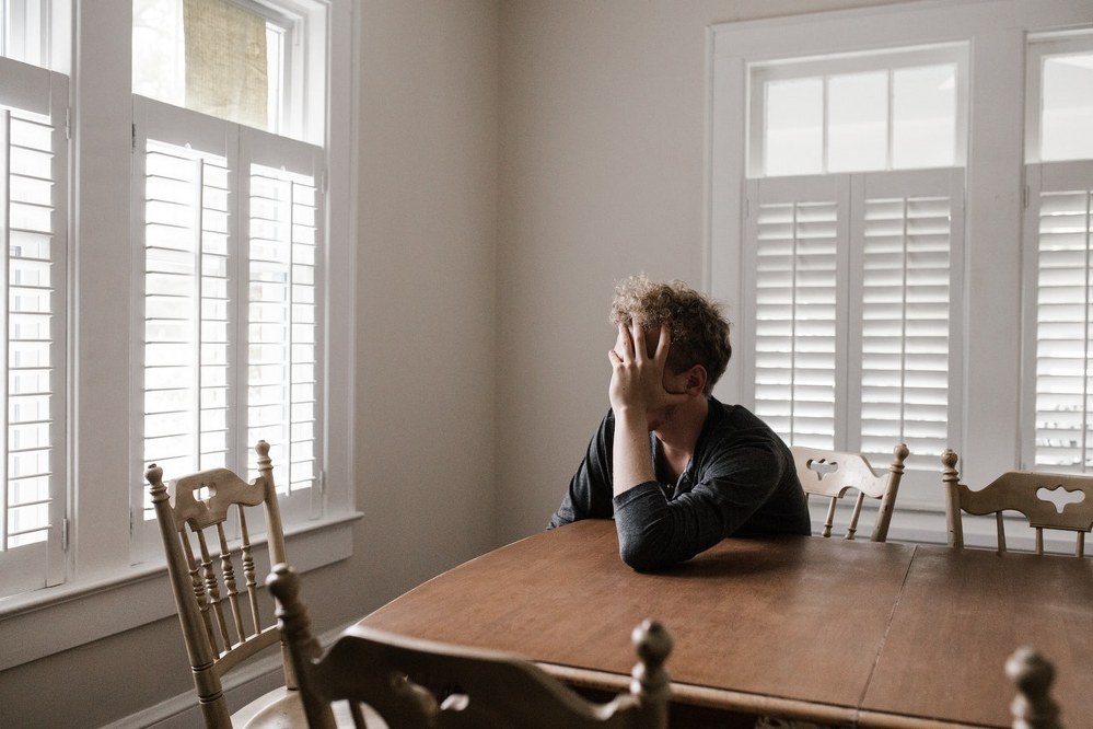 single man looking stressed and lonely