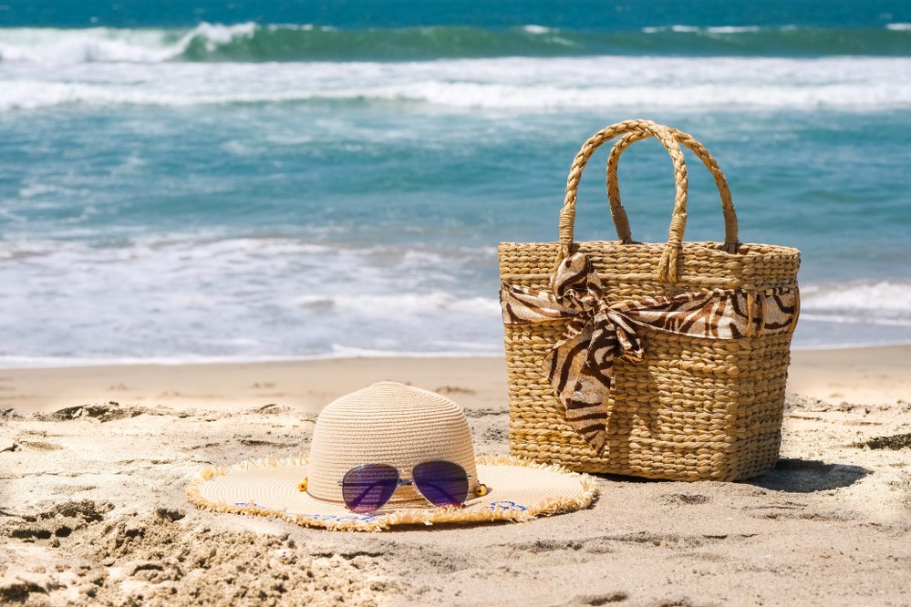 sunhat and sun glasses and bag on beach