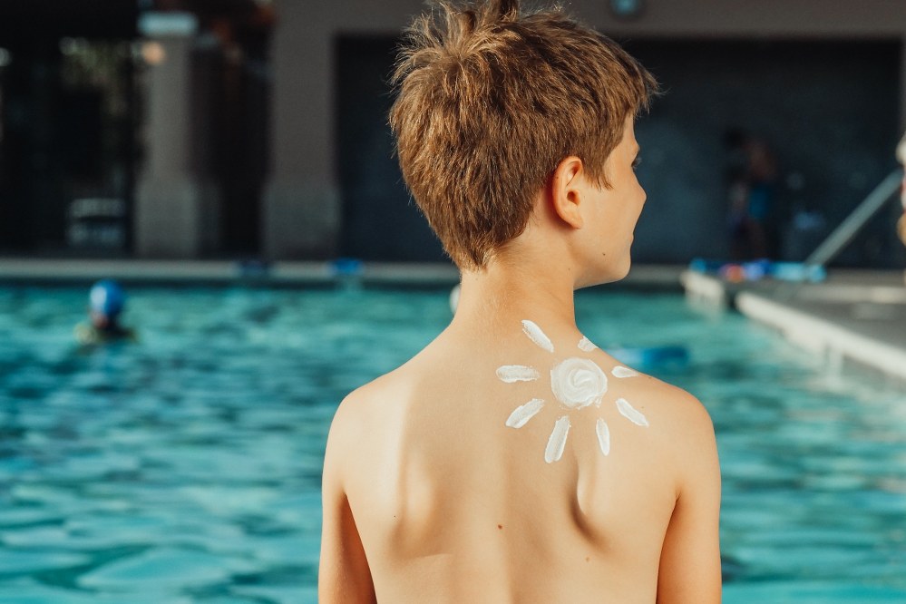 boy by the pool in shunshine