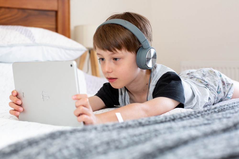boy with headphones and ipad - online safety