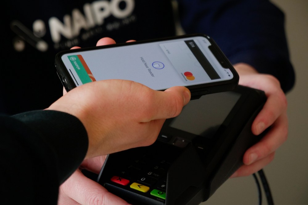 person paying with phone