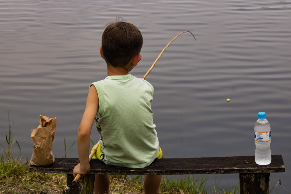 boy fishing at lake
