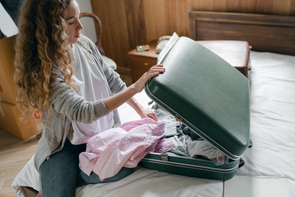woman packing suitcase for holiday