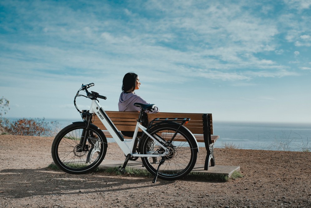 woman with e-bike near beach
