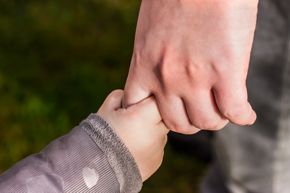 single parents holding child's hand