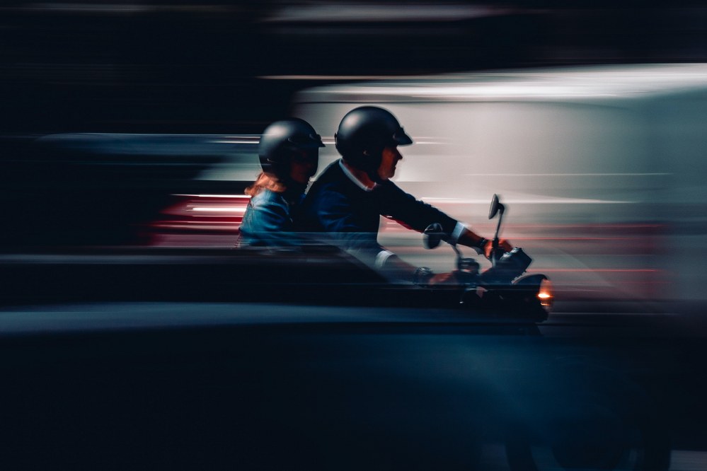 girl holding on to dad riding motorbike