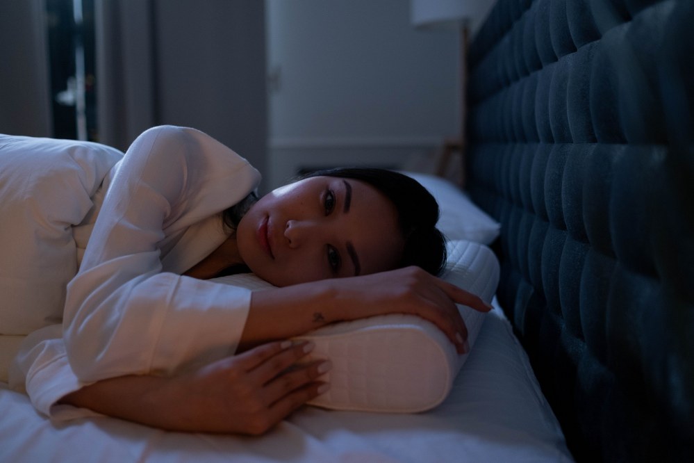 woman lying on comfortable pillow