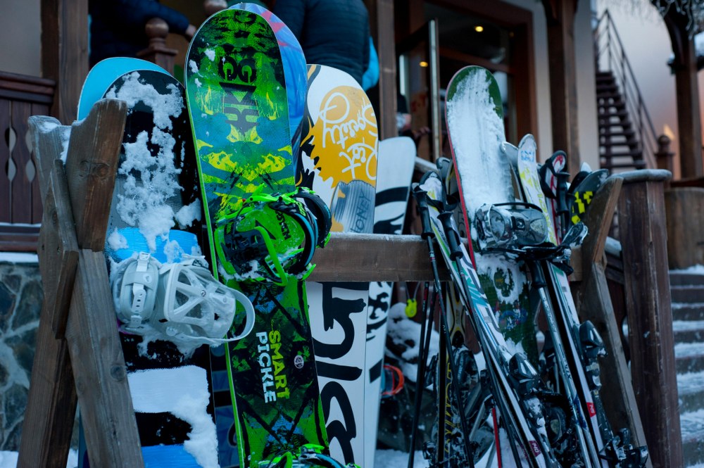 skis and snowboards on rack