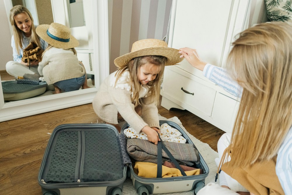 single mum and child packing suitcase