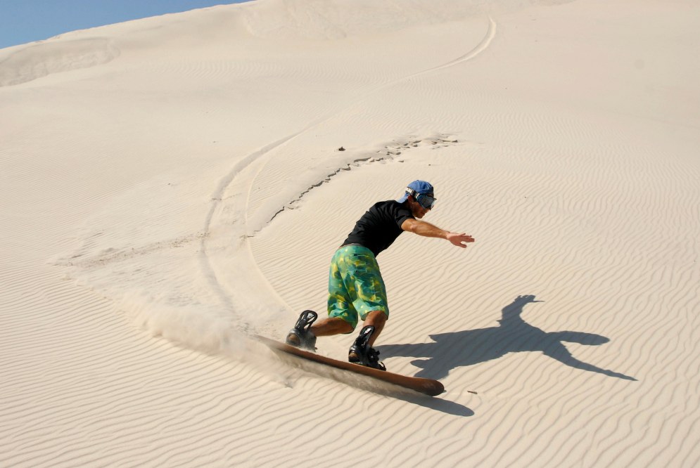 sandboarding in the desert - best holidays with teenagers