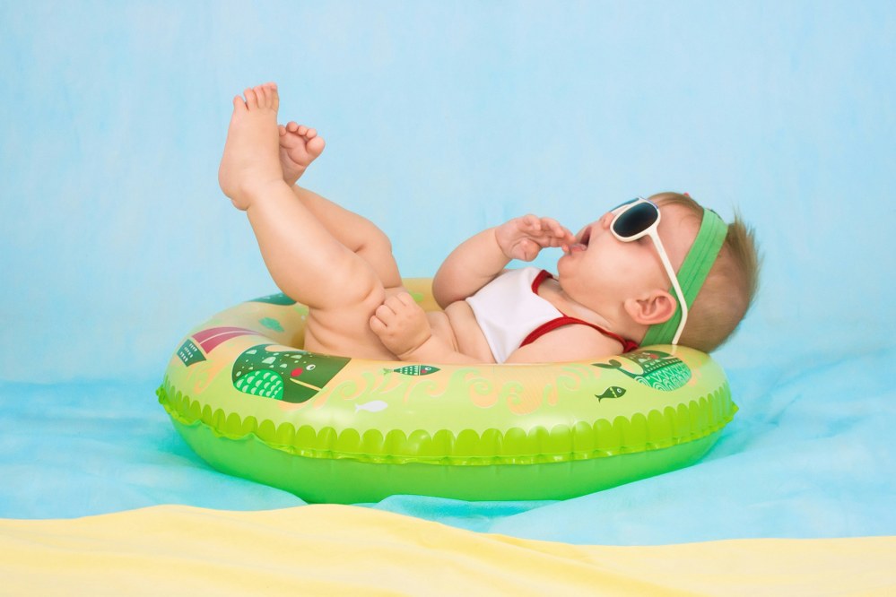 baby relaxing on holiday in the pool