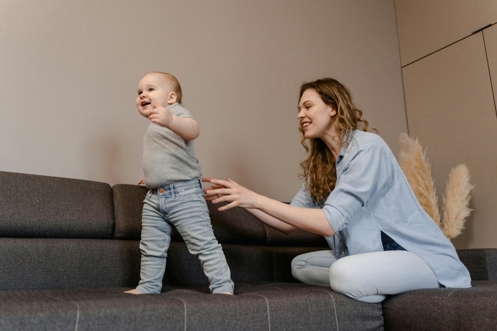 single mother with baby taking first steps