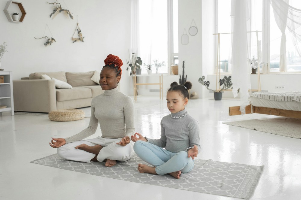 mum and daughter meditating / yoga