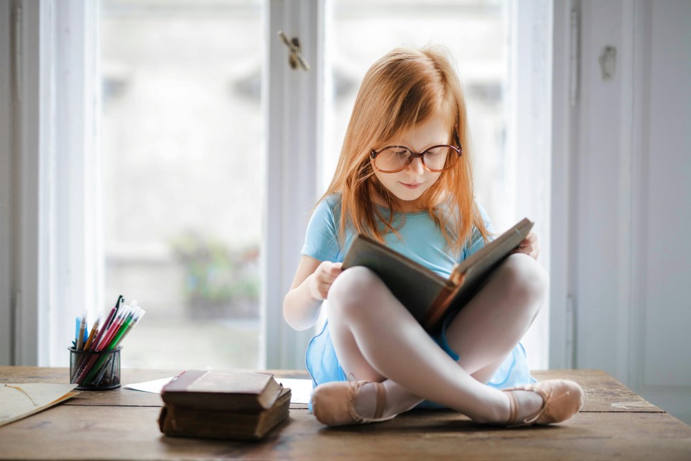 young girl reading a book