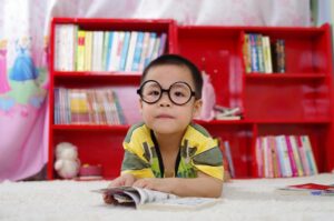young boy reading book