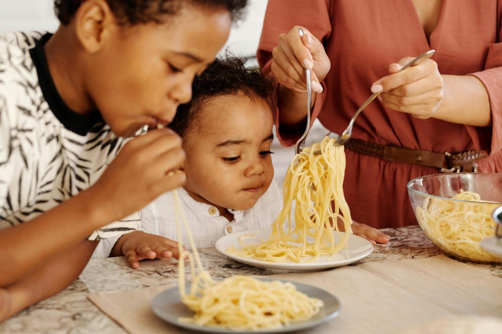 mum and kids making pasta