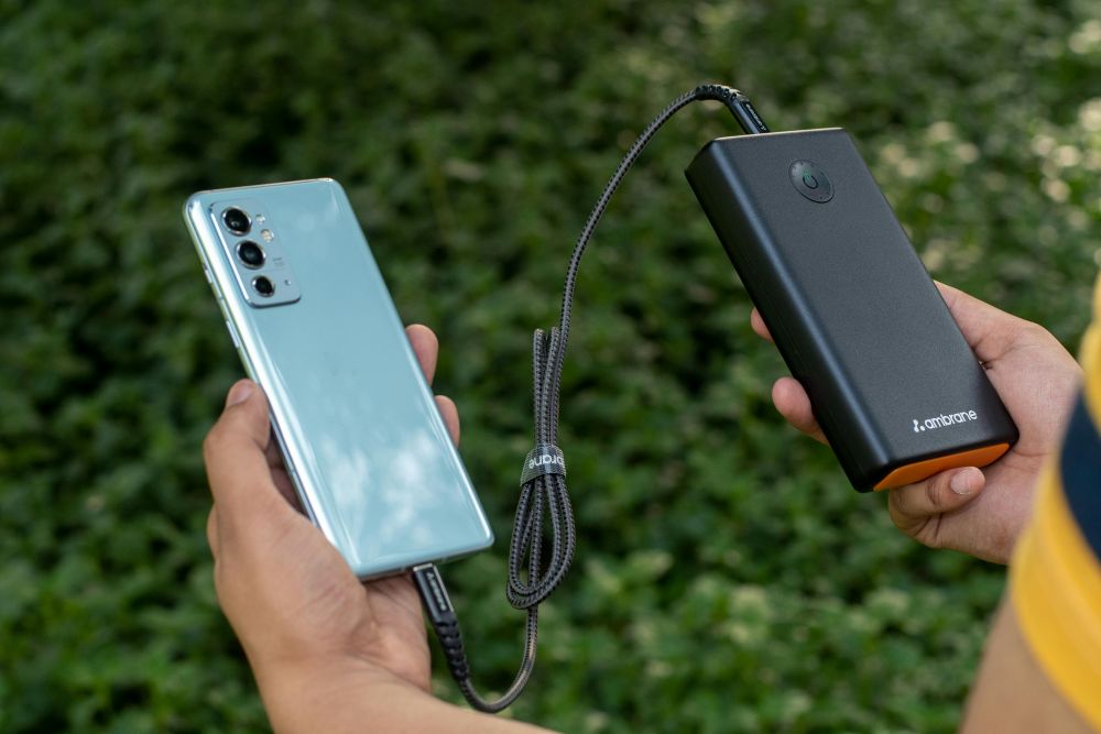 teenager holding power bank and charging mobile phone