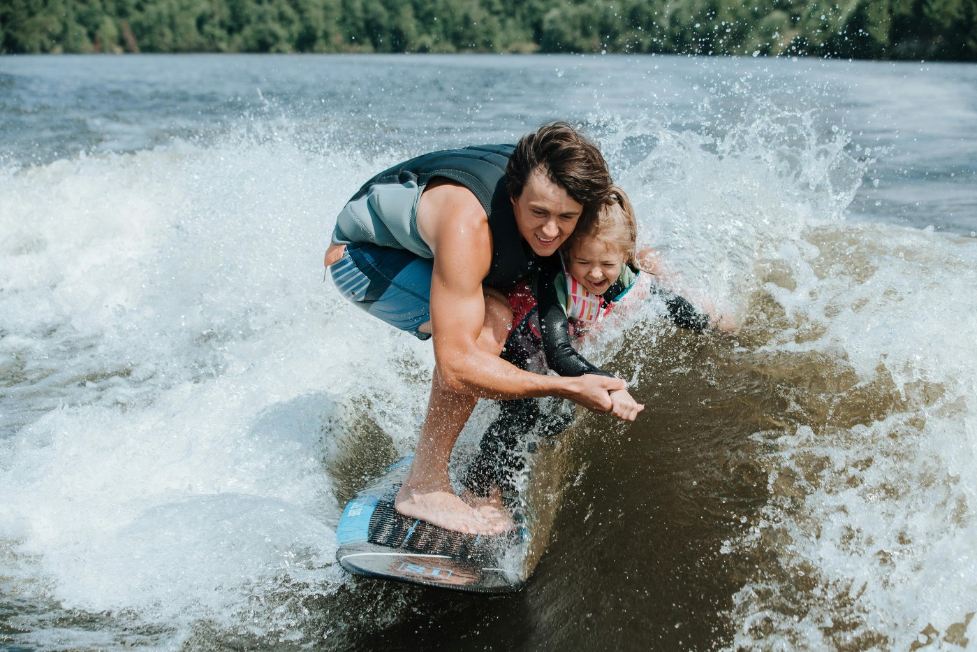 dad and daughter bonding by learning wakeboarding